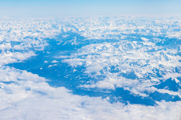 An aerial view of the Alps, a European mountain range and also the highest and most extensive mountain range that is entirely in Europe, stretching approximately 1,200 km across eight Alpine countries