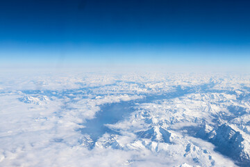 An aerial view of the Alps, a European mountain range and also the highest and most extensive...