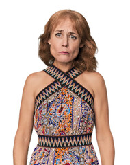 Redhead mid-aged Caucasian woman in studio sad, serious face, feeling miserable and displeased.
