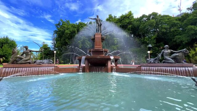 Monday 18 March 2024 Hyde Park water fountain Sydney in afternoon is in the heart of the CBD. trees flowers and pedestrians Sydney NSW Australia