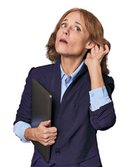 Mid-aged Caucasian with laptop in studio trying to listening a gossip.