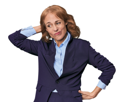 Mid-aged Caucasian businesswoman in blazer touching back of head, thinking and making a choice.