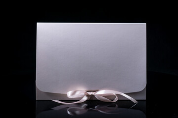 Man gift concept. gift box with luxury bow on dark background. Horizontal with copy space.