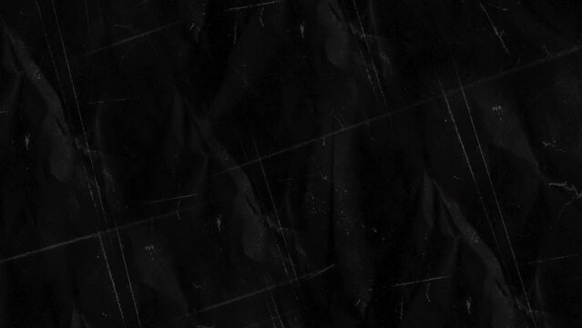 Stop motion animated paper texture background. Crumpled Black Paper Looping Animation in 4k. Quick changing.