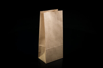 Recyclable craft paper bag for purchases, gifts and takeaway food mock up on black background....
