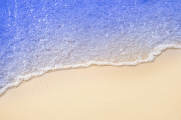 Top view of background for summer vacation concept. Nature of the beach and sea, summer with sunlight, sandy beach The sparkling sea water contrasts 