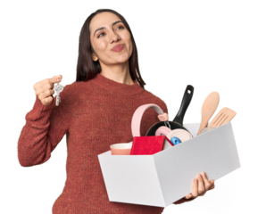 Young Caucasian woman holding moving box and keys