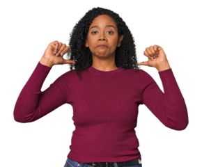 African American woman in studio setting feels proud and self confident, example to follow.