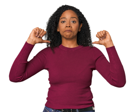 African American woman in studio setting feels proud and self confident, example to follow.