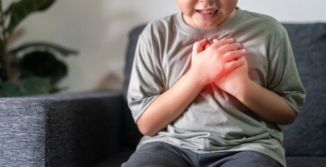 Asian boy with chest pain suffering from heart attack, health and medical, heart health, heart attack, world heart day, cardiovascular disease.insurance and hospital concept © Art_Photo