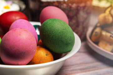 Painted eggs on the Easter holiday table. Easter brunch with eggs and pastries on the holiday table.