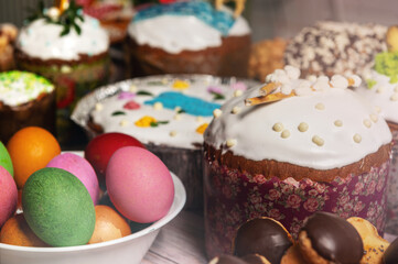 Painted eggs on the Easter holiday table. Easter brunch with eggs and pastries on the holiday table.