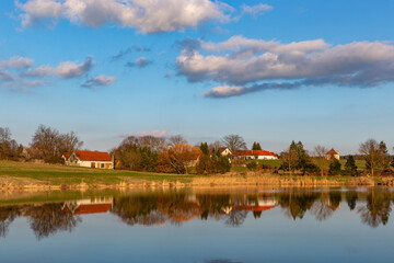 Evening over village on a lake bank. Early springtime.