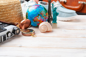 Travel planning simple background of compass, film camera, straw hat, globe and New York and Paris...