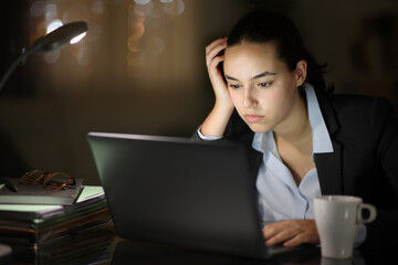 Serious executive working online in the night - 761245742