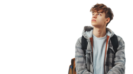 A young man confidently perches atop a rustic wooden chair, his expression calm and collected