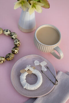 Cup of coffee, quail eggs and homemade wool napkin ring