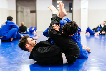 Athletes doing jujitsu training at dojo
