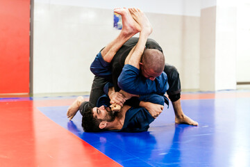 Athletes doing jiu-jitsu training at dojo