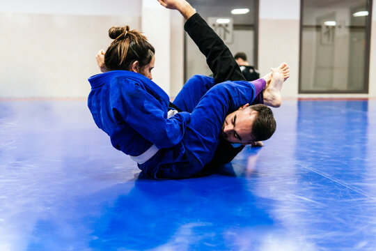 Athletes practicing jujitsu at dojo