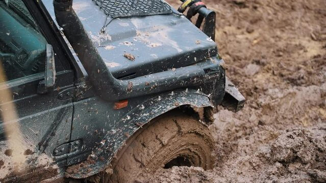 high angle view of a car stuck in the mud, off trial 4x4 cars concept. High quality 4k footage