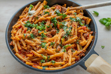 Pasta pan with macaroni, minced meat, tomatoes, herbs and parmesan cheese
