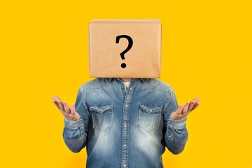 Man With His Head Box With Question Sign Drawn It Asking Hands Yellow Backgroun - obrazy, fototapety, plakaty