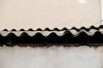 Dangerous asbestos roof. Asbestos dust in the environment. Health problems