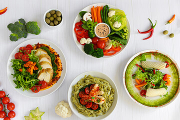 Dietary salads made from fresh vegetables, seafood and white chicken meat. Keto diet.