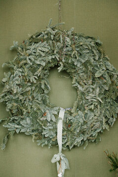 A magnificent New Year's wreath on the background of a green wall