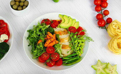 Baked chicken with vegetables, pumpkin puree and arugula. Keto diet food.