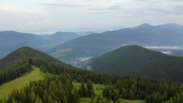 4K aerial - a bird's eye view video (Ultra High Definition) of Yahidna mount. Green summer scene of Carpathian mountains, Ukraine, Europe. Beauty of nature concept background..
