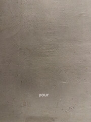 Your text written on grey wall. Conceptual texting.
