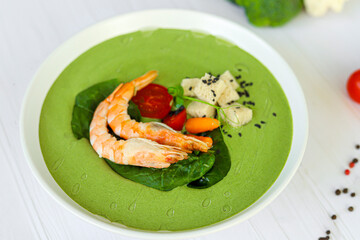 Seafood soup with spinach and croutons, mushrooms. Decorated with shrimps.