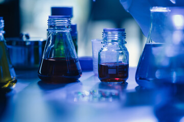 biochemical research scientists working with a microscope for vaccine development in pharmaceutical research labeling.