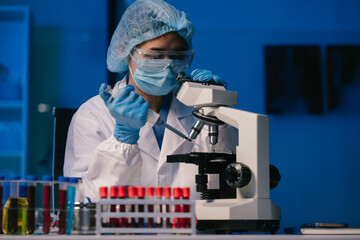 biochemical research scientists working with a microscope for vaccine development in pharmaceutical...
