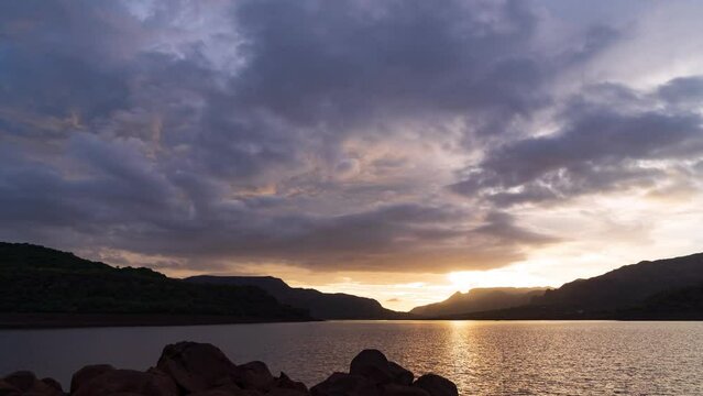 Timelapse - Amazing sunset over lake with clouds and colour explosion 4K60