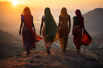Indian women in colorful sari on top of hill - obrazy, fototapety, plakaty