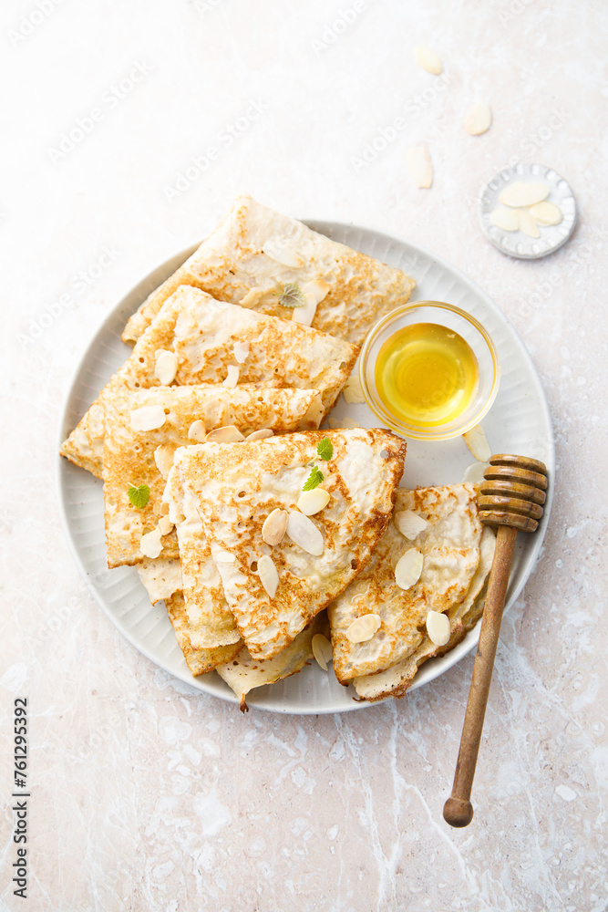 Poster homemade crepes with almond and honey