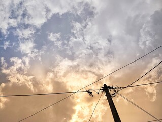 Silhouette of electric pole under the sky