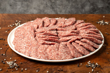 Meatballs made from raw beef mince. Butcher products. Uncooked meatballs on a dark background. Close up