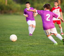 Boys play soccer sports field