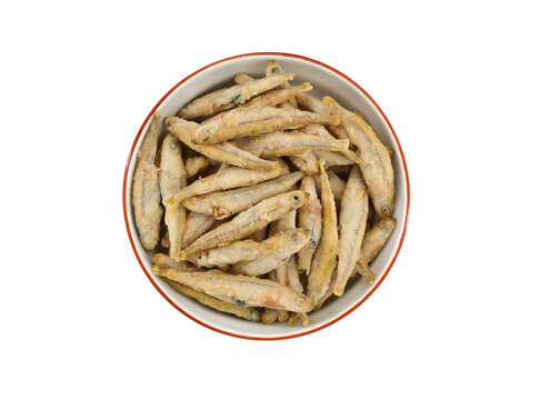 Crispy fried Sand Smelt fish in a plate on white background. Top view.