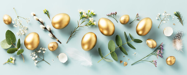 golden quail eggs, feathers and spring flowers