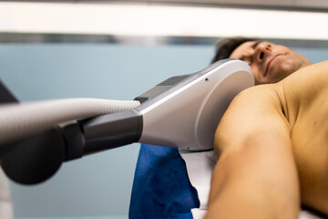 An adult man undergoes super inductive system therapy for recovery from trauma and rheumatic...
