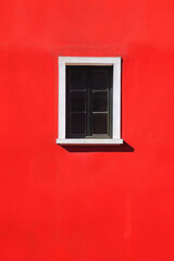 Vibrant Red Wall with Minimalist Black Window Design