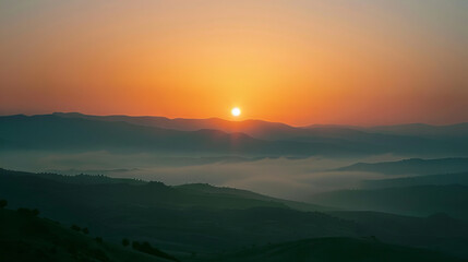 Naklejka premium Majestic Sunrise Over Misty Mountain Landscape