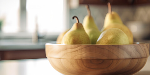 Pears in a bowl on the kitchen table on a blurred background - 761310555