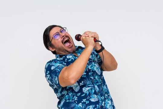 A rowdy and possibly drunk middle aged tourist shouting into the microphone during a fun karaoke night.