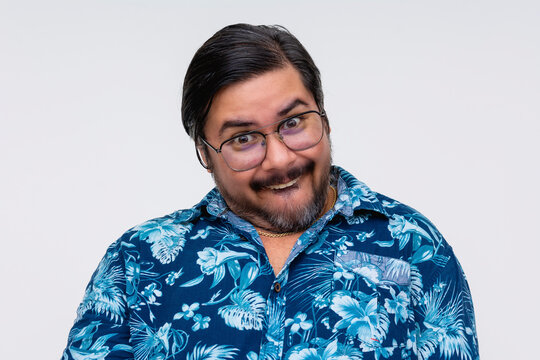 A nerdy or derpy looking middle aged man grinning, upper front teeth out. Isolated on a white background.